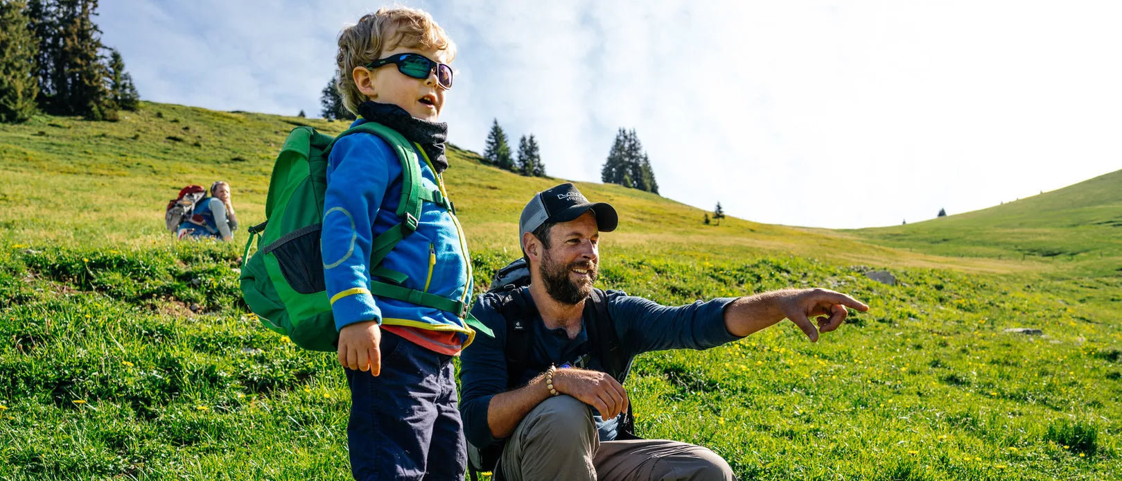 Man pointing something out to young boy