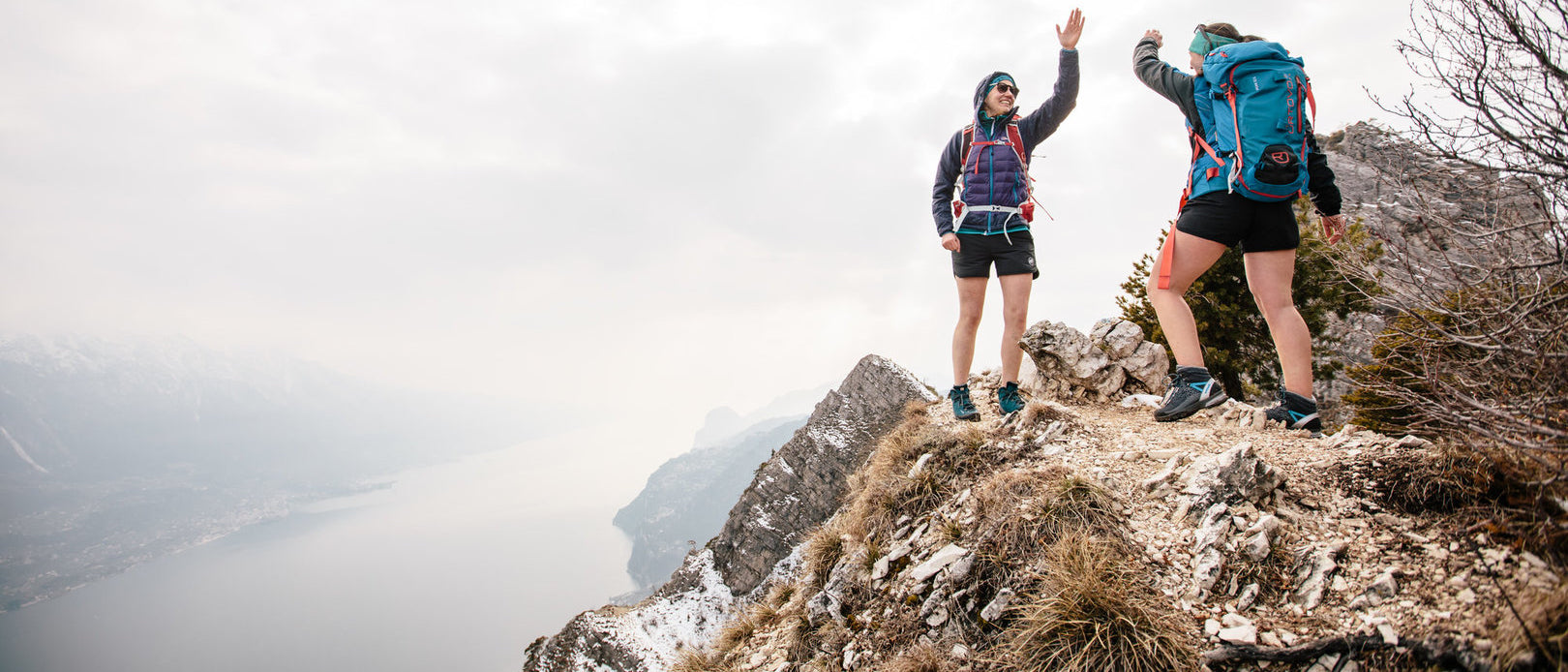 Women high fiving on mountain