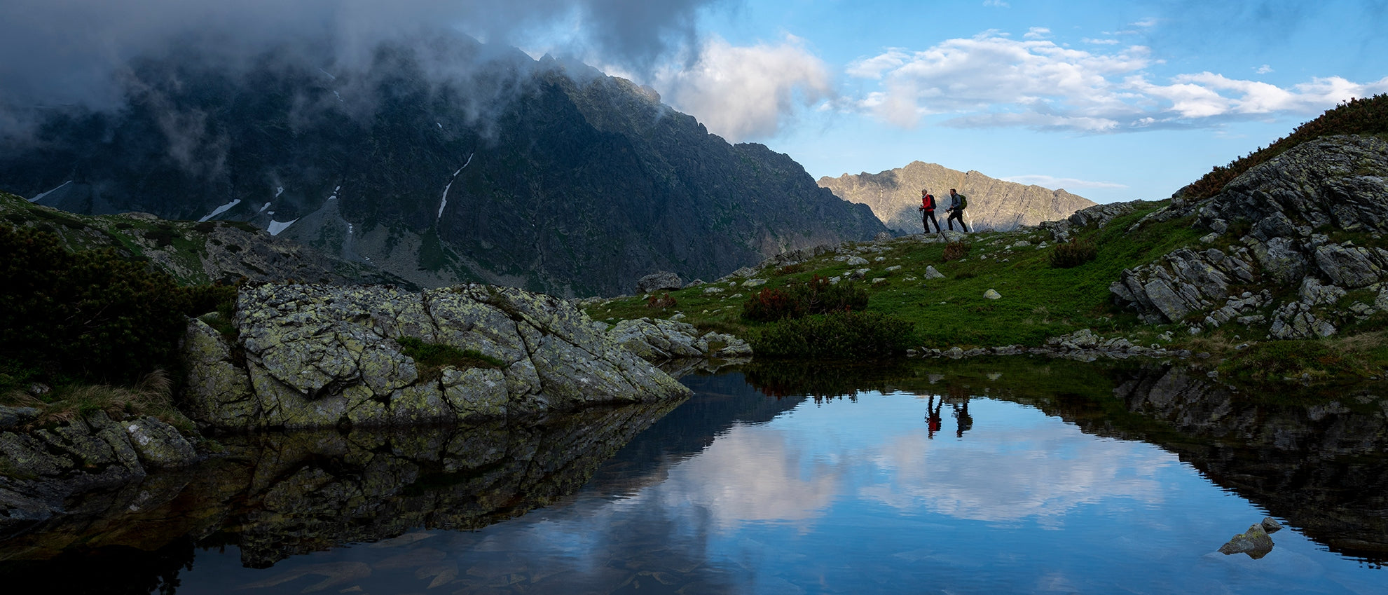 Hikers Reflected in Tarn