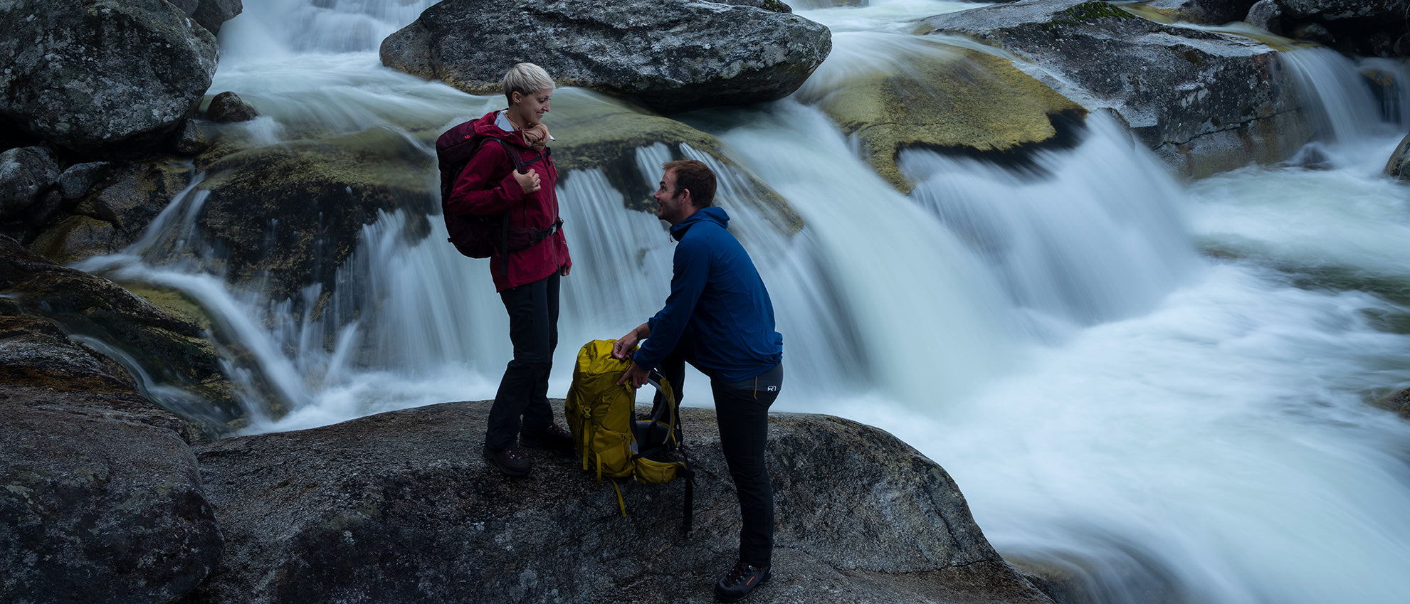 2 Hikers in front of fast flowing water