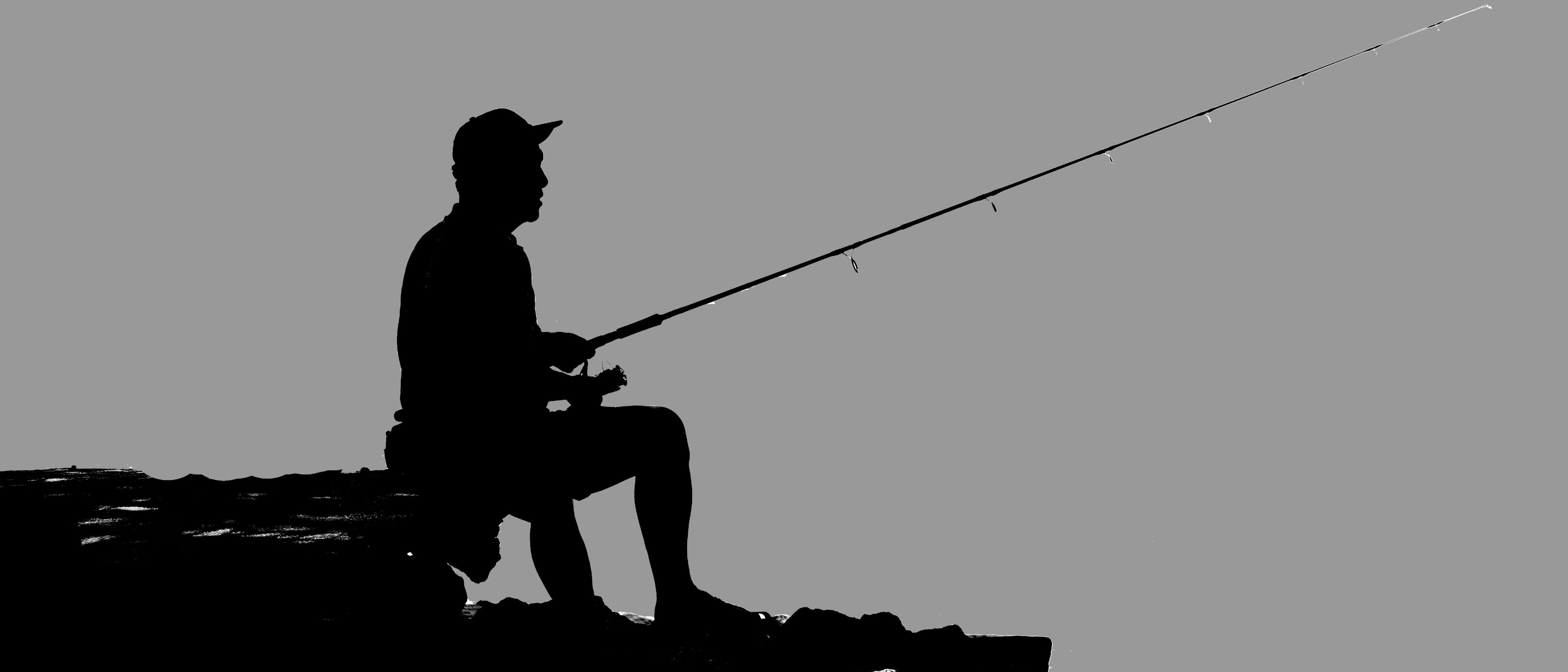 Man Sitting Fishing Silhouetted